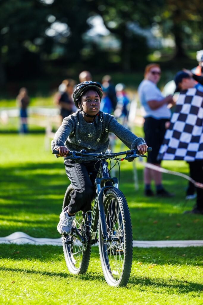 Young rider passing the chequered flag at Inch Park