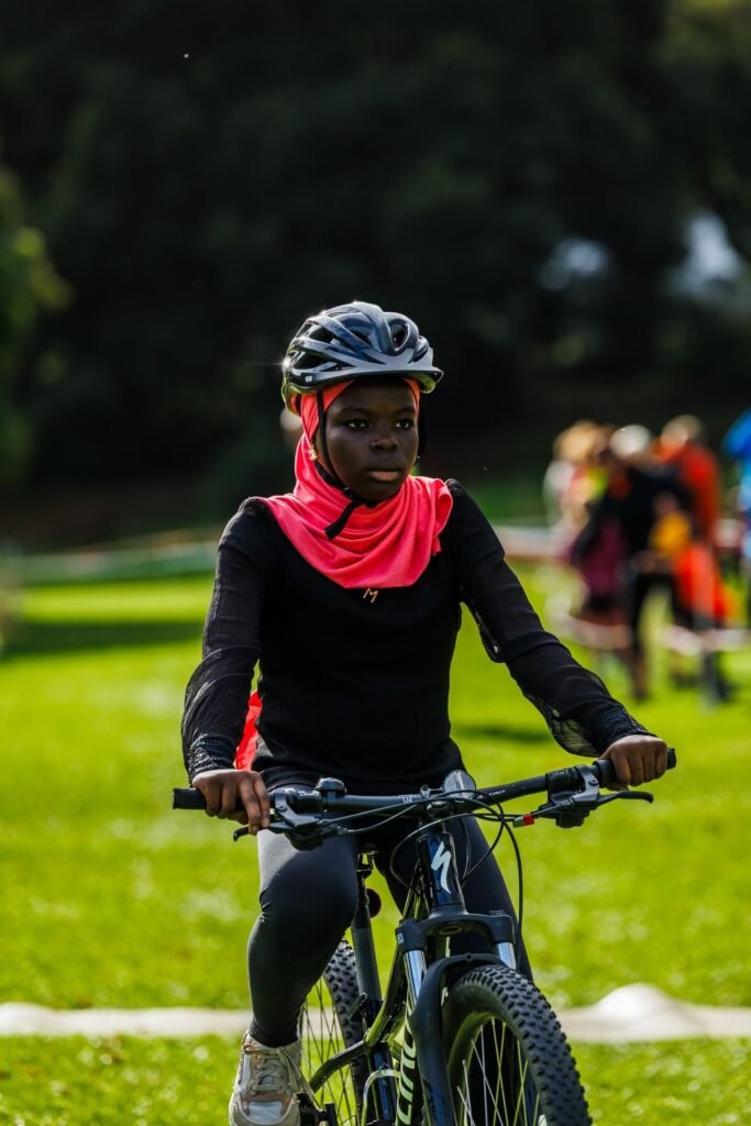 Young rider in a red headscarf on her mountain bike at Inch Park