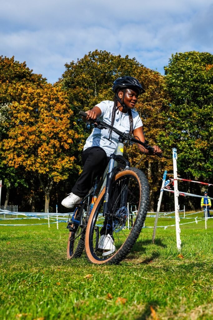 Young rider in a white top concentrating on the course