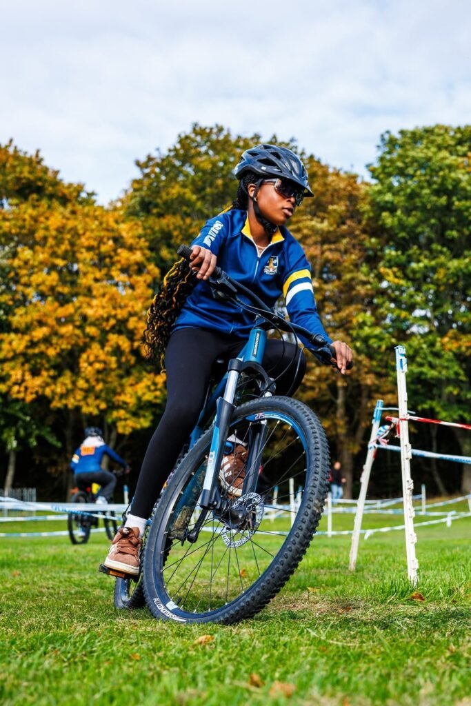 Young rider in a blue jacket racing at the Inch Park Cyclocross