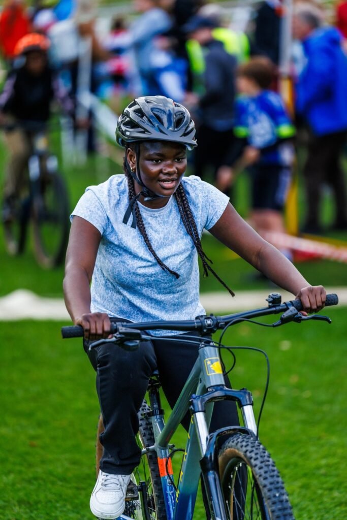 Smiling young rider in a light blue T-shirt at the Inch Park Cyclocross